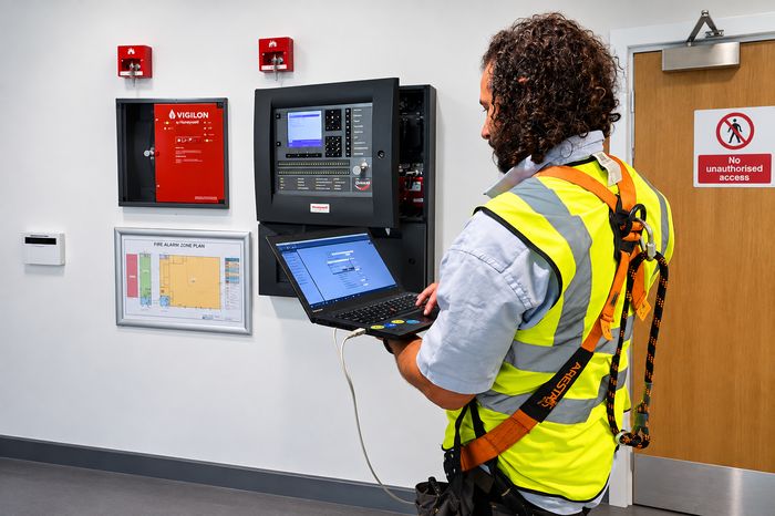 Array Fire Protection engineer programming a Notifier PEARL fire alarm panel